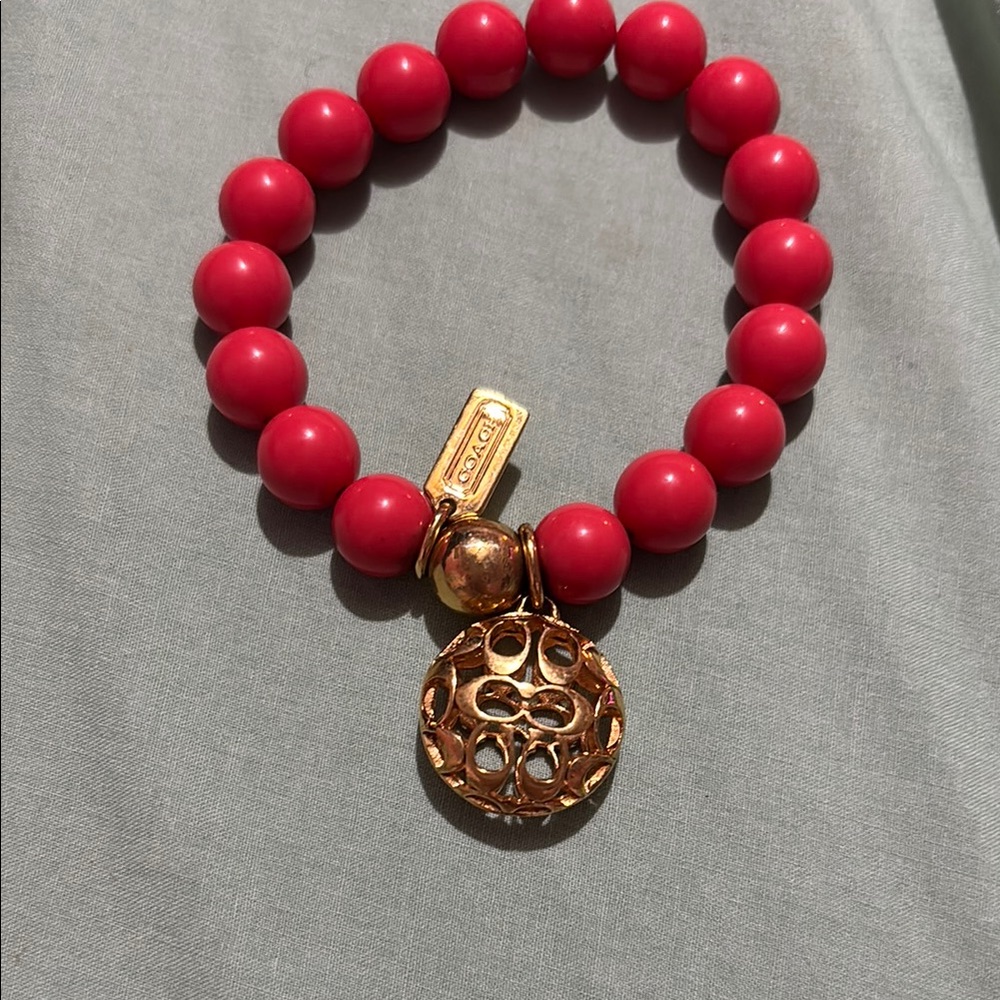 Coach Dark Orange/ Red and Gold Bracelet with Smooth Beads and Elegant Pendant